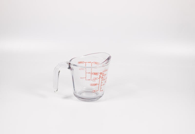Clear glass Pyrex measuring cup with red measurement markings